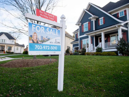 A house's real estate for sale sign is seen in front of a home in Arlington, Virginia, Nov