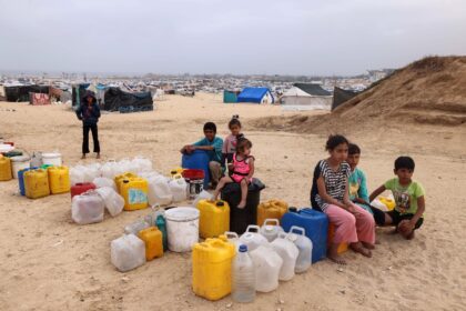 Displaced Palestinian children wait for water at their tent camp in Rafah -- the UN childr