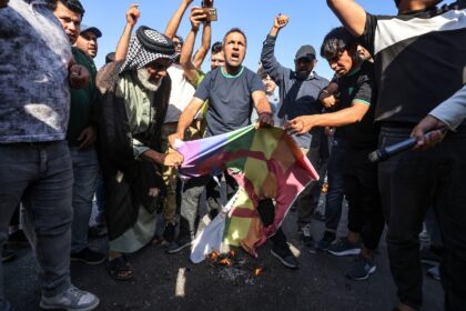 (FILES) Supporters of Shiite Muslim leader Moqtada Sadr burn a rainbow flag outside the Sw