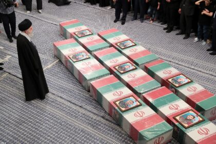 Iran's supreme leader Ayatollah Ali Khamenei leads prayers by the coffins of seven Revolut