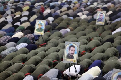 Iranians attend Friday noon prayer in Tehran, after explosions in the central region of th