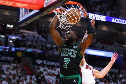 Jaylen Brown of the Boston Celtics throws down a dunk over Nikola Jovic in the Celtics' vi