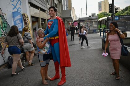 Leonardo Muylaert, 36, known as the Brazilian Superman, poses for a picture with a woman a