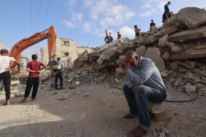 A Palestinian man waits for news of his daughter as rescue workers search for survivors af