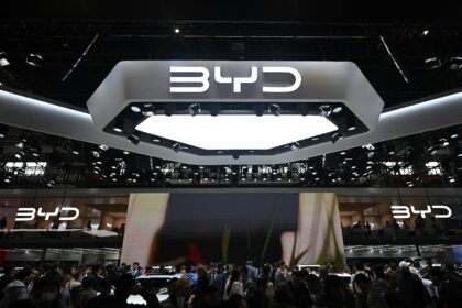 People visit the BYD stand at the Beijing Auto Show on April 29, 2024