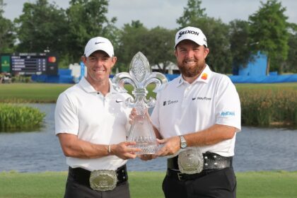 Rory McIlroy and Shane Lowry pose with the trophy after winning the Zurich Classic of New