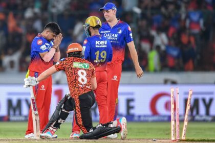 Royal Challengers Bengaluru's Karn Sharma (L) celebrates with teammates after taking the w