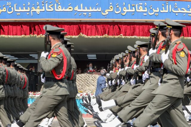 Soldiers march past Iran's President Ebrahim Raisi during a military parade in Tehran on A