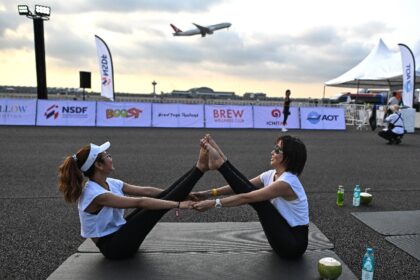 A sunrise "Brew Yoga" event on a runway at Bangkok's international airport on April 27, 20