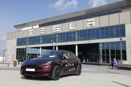 A Tesla car stands in front of the company's electric car plant in Gruenheide near Berlin,