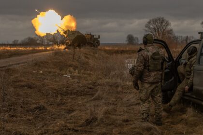 Ukrainian members of the 45th Artillery Brigade fire toward Russian positions in the Donet