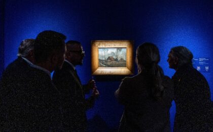 Visitors look at Van Gogh's "Country Huts Among Trees" at the Museum of John Paul II and P