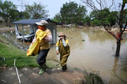 Workers cleared debris from a flooded areas