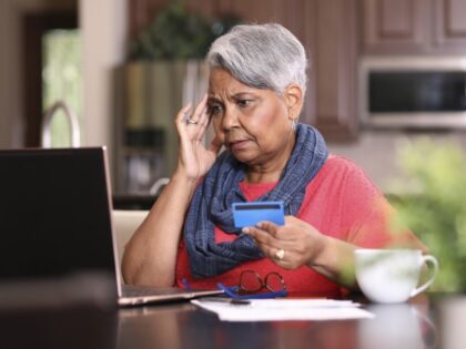 worried woman holding credit card