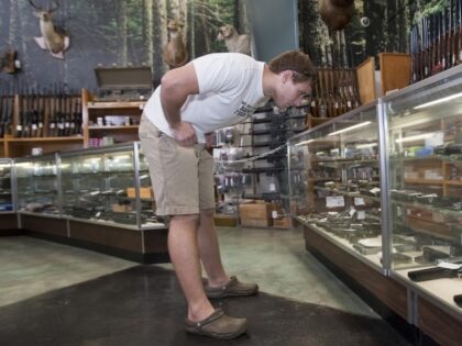 A young man shops for a handgun Thursday, Sept. 3, 2009, a day before the Louisiana Second