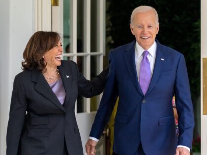 President Joe Biden walks with Vice President Kamala Harris along the West Colonnade of th