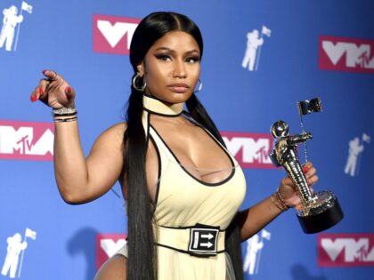 Nicki Minaj poses in the press room with her award for best hip-hop video for "Chun-Li" at
