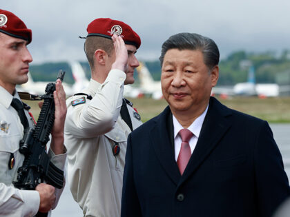 Chinese President Xi Jinping walks past soldiers as he arrives Tuesday, May 7, 2024 at the