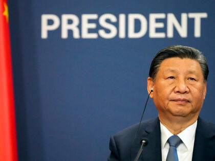 Chinese President Xi Jinping listens during a press conference after talks with Serbian Pr