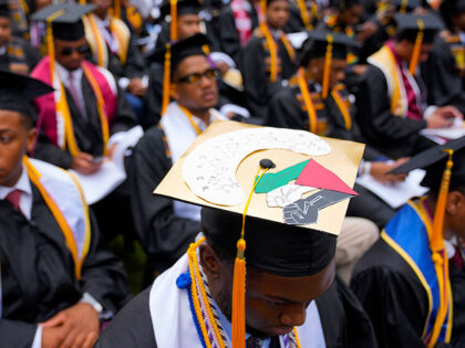 Valedictorian DeAngelo Jeremiah Fletcher shows his mortarboard with a protest image repres