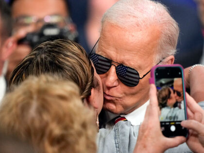 President Joe Biden kisses a supporter on her cheek after he spoke on the PACT Act, Tuesda