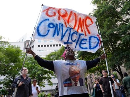 A demonstrator reacts to the guilty verdict announced against former President Donald Trum
