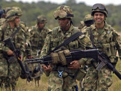 Soldiers patrol a field in Guerima, in the eastern province of Vichada, Colombia, Wednesda