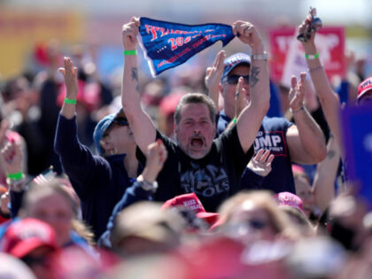 People cheer at a campaign rally for Republican presidential candidate former President Do