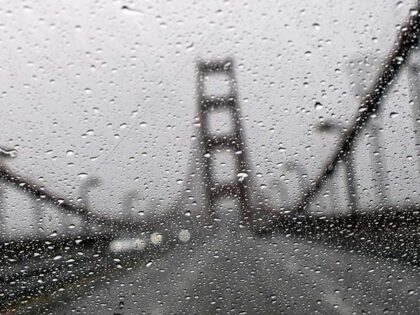 The Golden Gate Bridge is seen through a rainy windshield in San Francisco, California, on