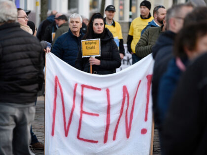 24 March 2023, Mecklenburg-Western Pomerania, Grevesmühlen: People protest with signs and