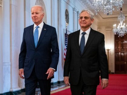US President Joe Biden arrives with Merrick Garland, US attorney general, right, during a