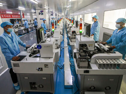 Employees work on the production line of chips at a factory of Huilipu China-Asia-Europe E
