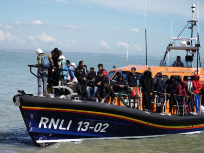 A group of people thought to be migrants are brought in to Dungeness, Kent, onboard an RNL