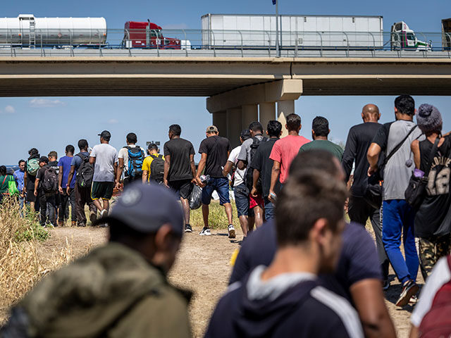 Immigrants walk towards a U.S. Border Patrol checkpoint after crossing the U.S.-Mexico bor