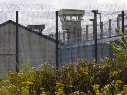 Watchtower behind barbed wire fences at a UK Prison