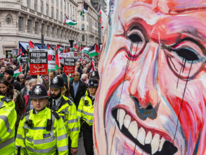 Tens of thousands of pro-Palestinian protesters pass a huge mask of Leader of the Oppositi