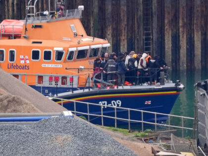 A group of people thought to be migrants are brought in to Dover, Kent, onboard the RNLI D