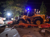 AMSTERDAM, THE NETHERLANDS - MAY 7: A bulldozer destroy tents as police mobile unit interv
