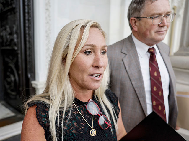 Rep. Marjorie Taylor Greene (R-GA), and Rep. Thomas Massie (R-KY), speak to members of the