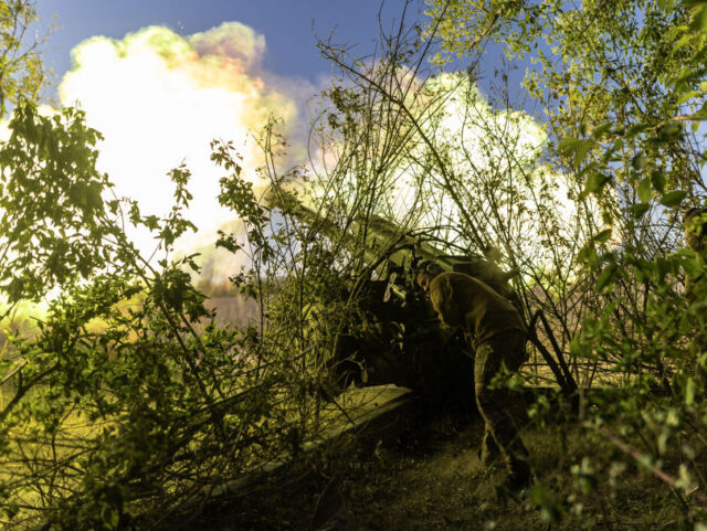 DONETSK OBLAST, UKRAINE - MAY 12: Ukrainian soldiers fire D-30 artillery at their fighting