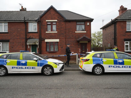 WIGAN - UNITED KINGDOM MAY 09: Police tape cordons off a home in the Abram area of Wigan a