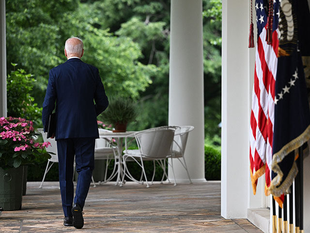 US President Joe Biden walks back to the Oval Office after speaking about new actions to p