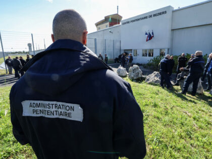 Prison officers gather and block the entrance of the jail during a protest in Beziers, sou