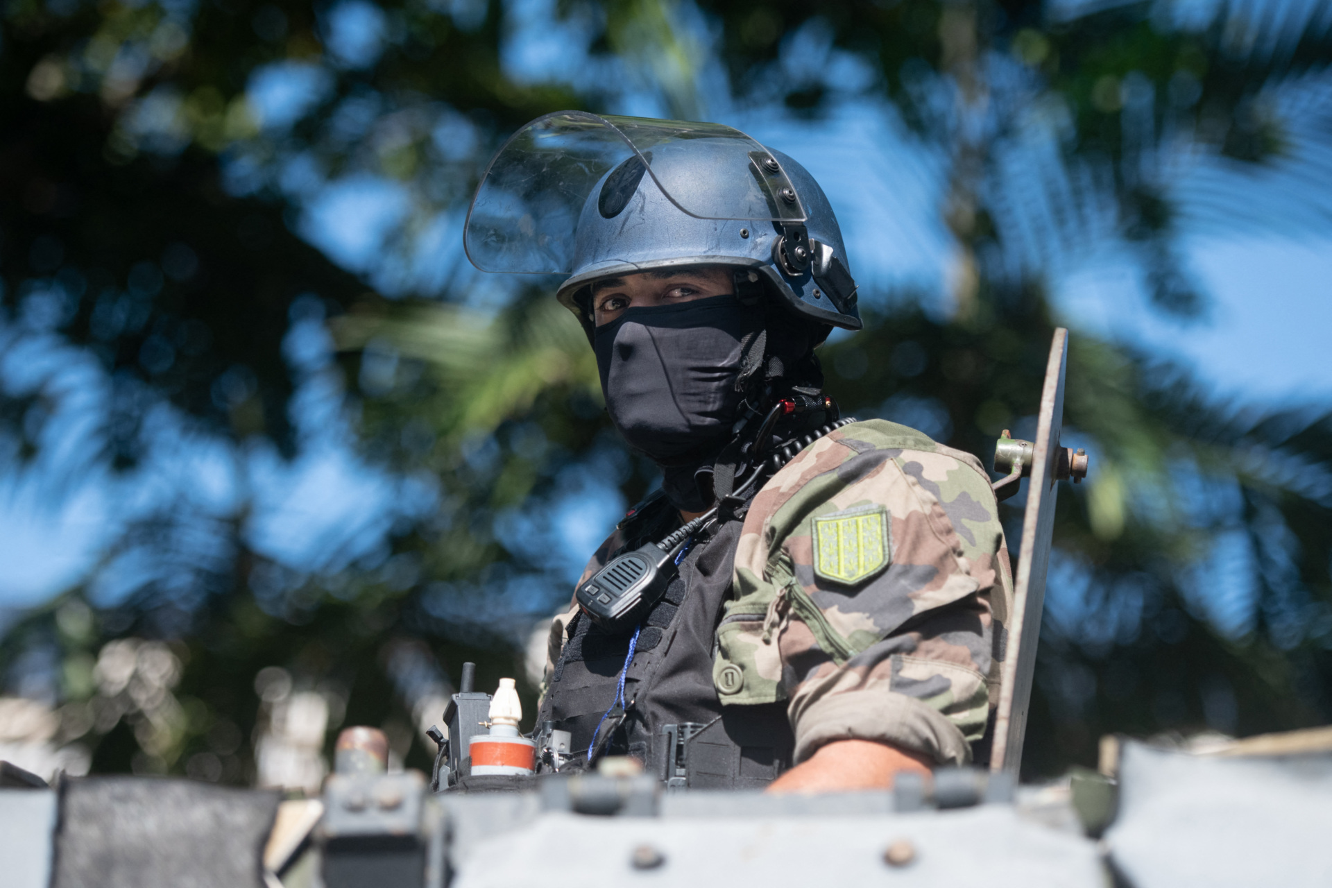 TOPSHOT - A security official looks on from an armoured vehicle in Noumea, France's Pacific territory of New Caledonia, on May 18, 2024. Hundreds of French security personnel tried to restore order in the Pacific island territory of New Caledonia on May 18, after a fifth night of riots, looting and unrest. (Photo by Delphine Mayeur / AFP) (Photo by DELPHINE MAYEUR/AFP via Getty Images)