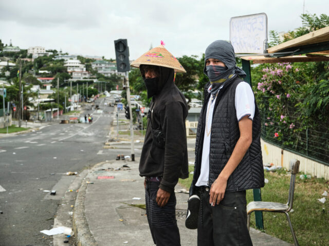 TOPSHOT - Two Independence activists manning makeshift roadblocks at Magenta Tours distric