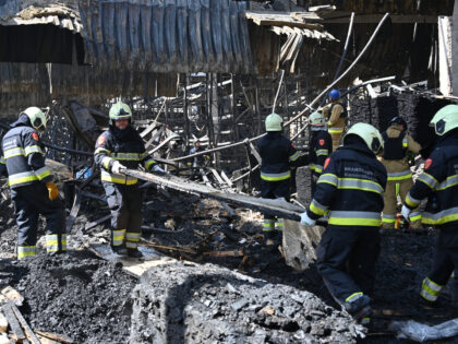 Employees of the State Emergency Service of Ukraine sort out the debris in a hardware supe