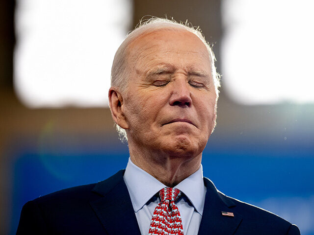 U.S. President Joe Biden stands on stage as U.S. Vice President Kamala Harris introduces h