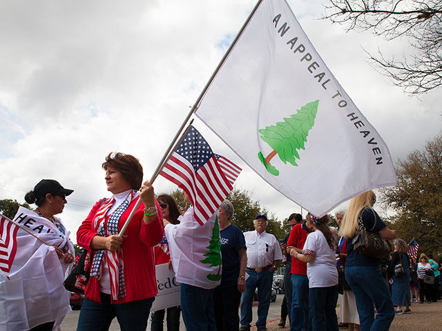 Cynthia Guzowski (far left) and Beth Walker (center with flag) hold The Tree Flag (or Appe