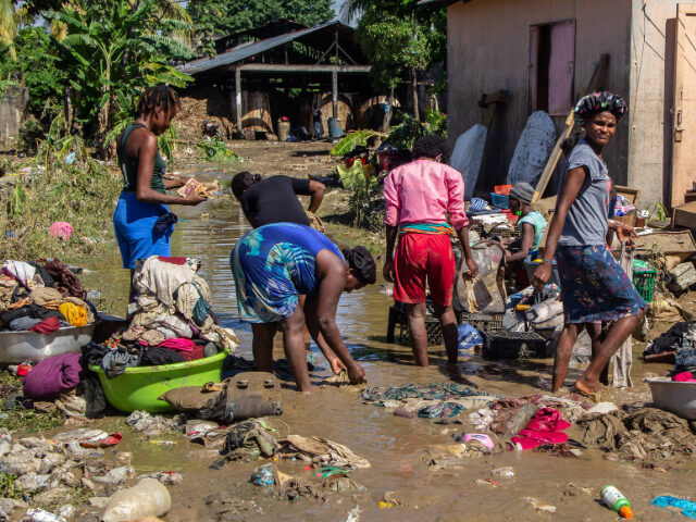 LEOGANE, HAITI - JUNE 05: Residents clean up damaged clothes in the town after flooding in