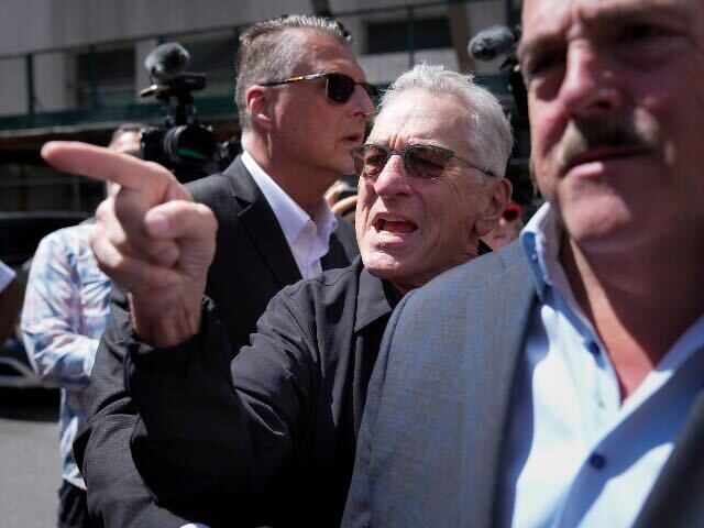 Robert De Niro, center, argues with a Donald Trump supporter after speaking to reporters i